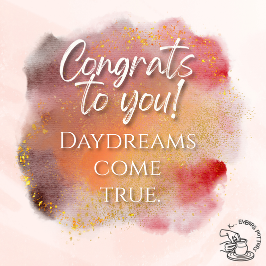 Various shades of red, orange, pink, dark purple watercolor blots with gold leaf speckles. Text reads "congrats to you! Daydreams come true." 