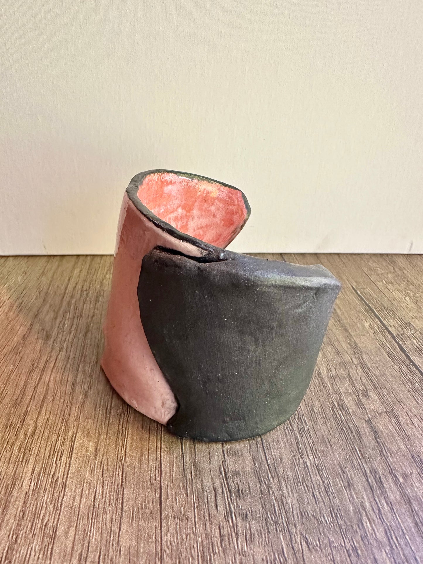 Side view of ceramic multi-colored candle holder in neutral daylight.