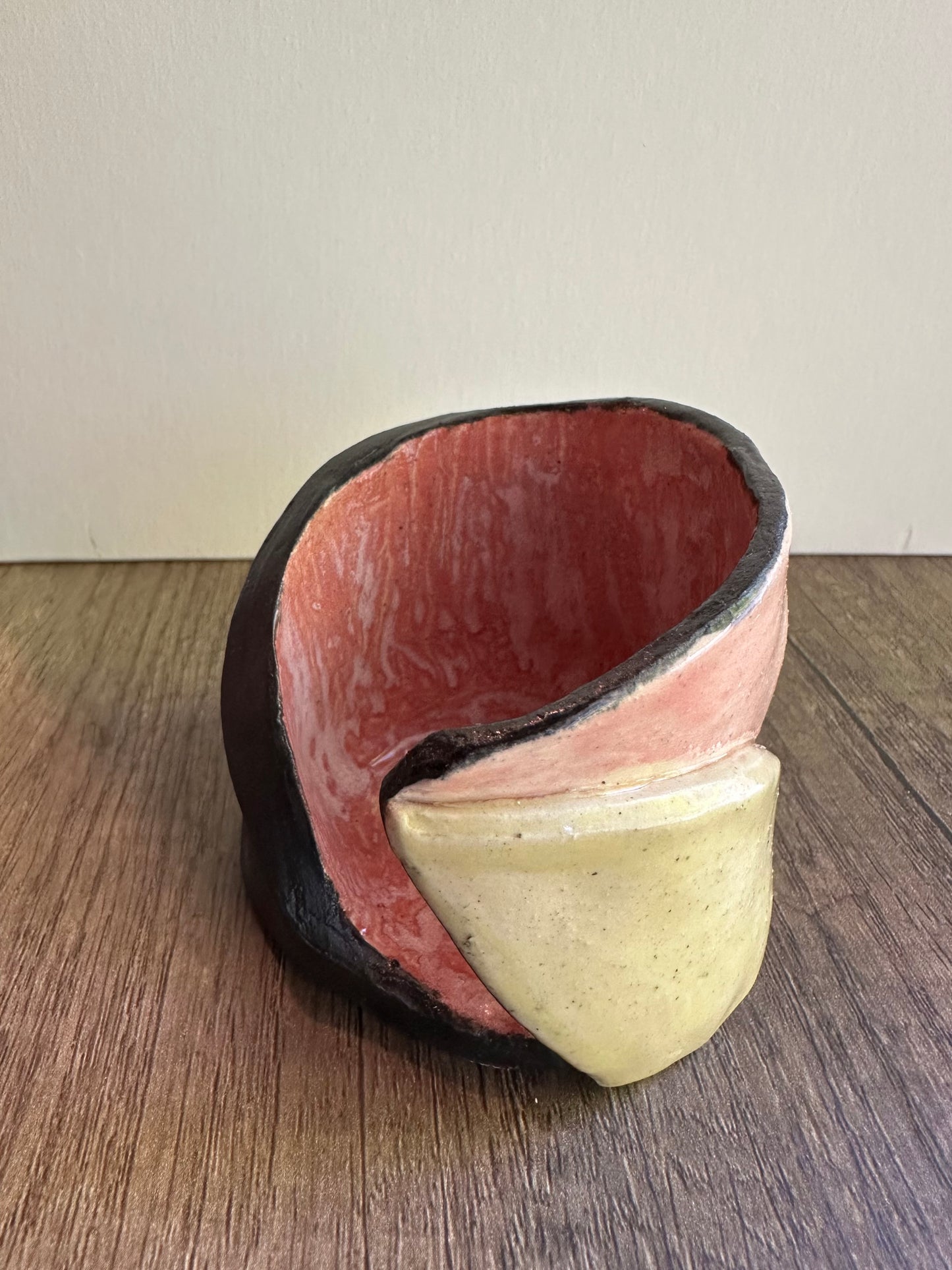 Ceramic multi-colored candle holder in neutral daylight.