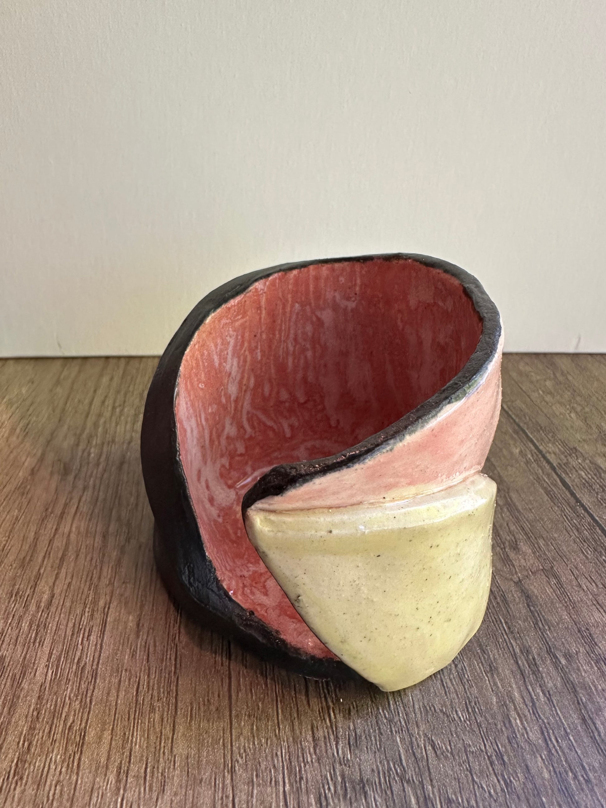 Ceramic multi-colored candle holder in neutral daylight.