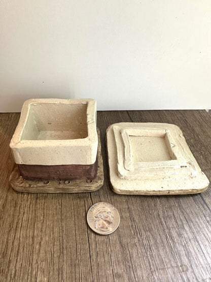 Smores-themed box with lid removed and placed aside, with coin for size reference.